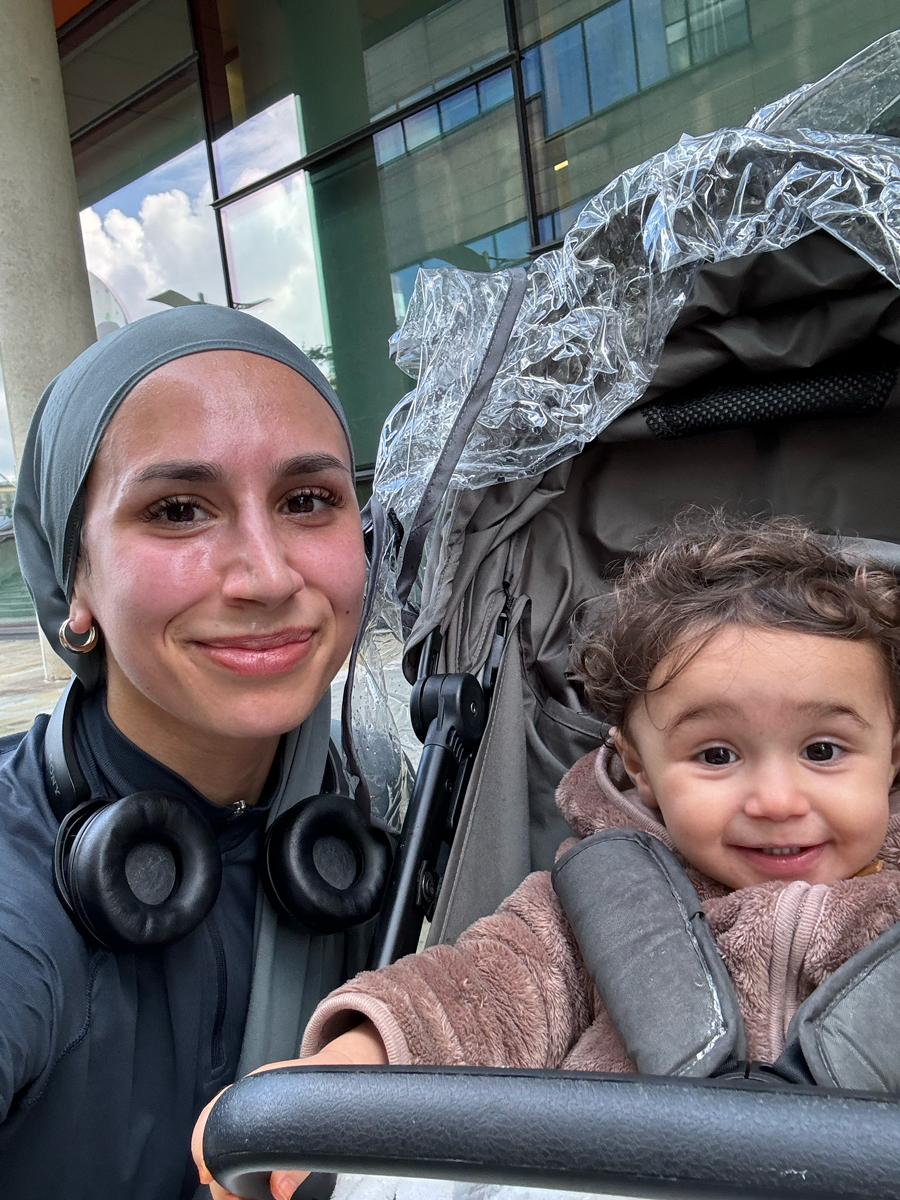 Coach is posing together with her young child.
